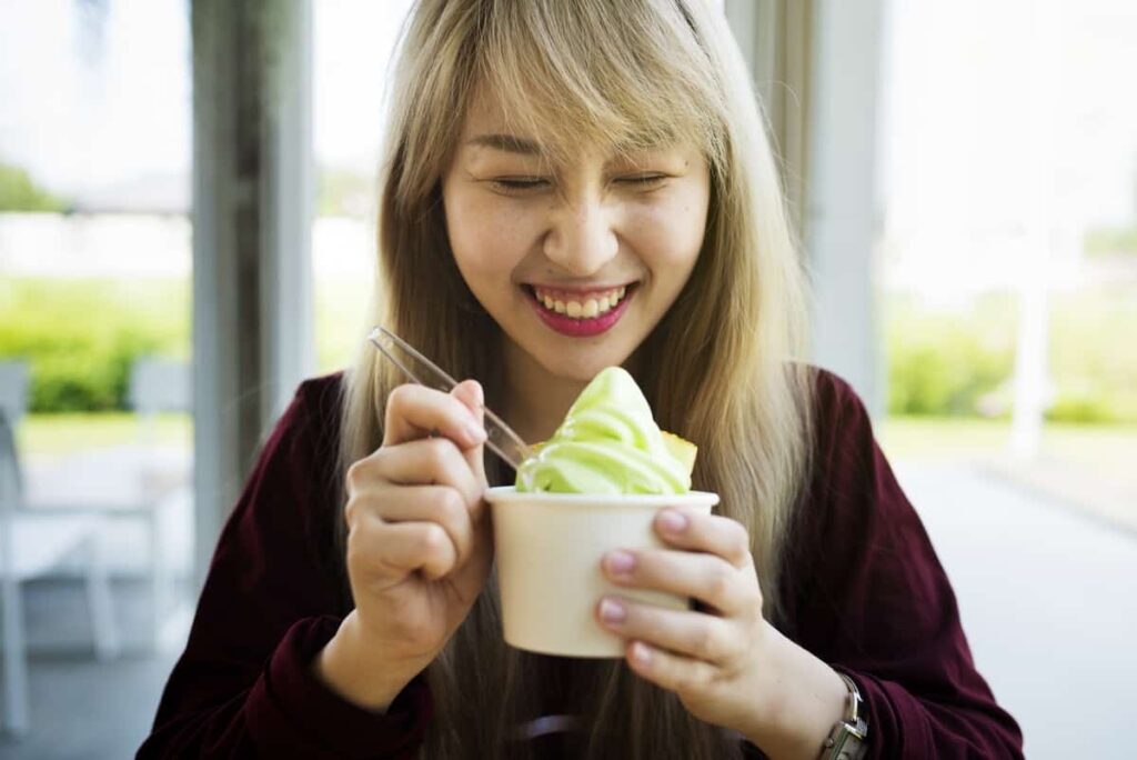 woman eating ice cream - weird pregnancy symptoms