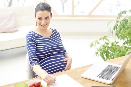 Pregnant woman being a work from home mom